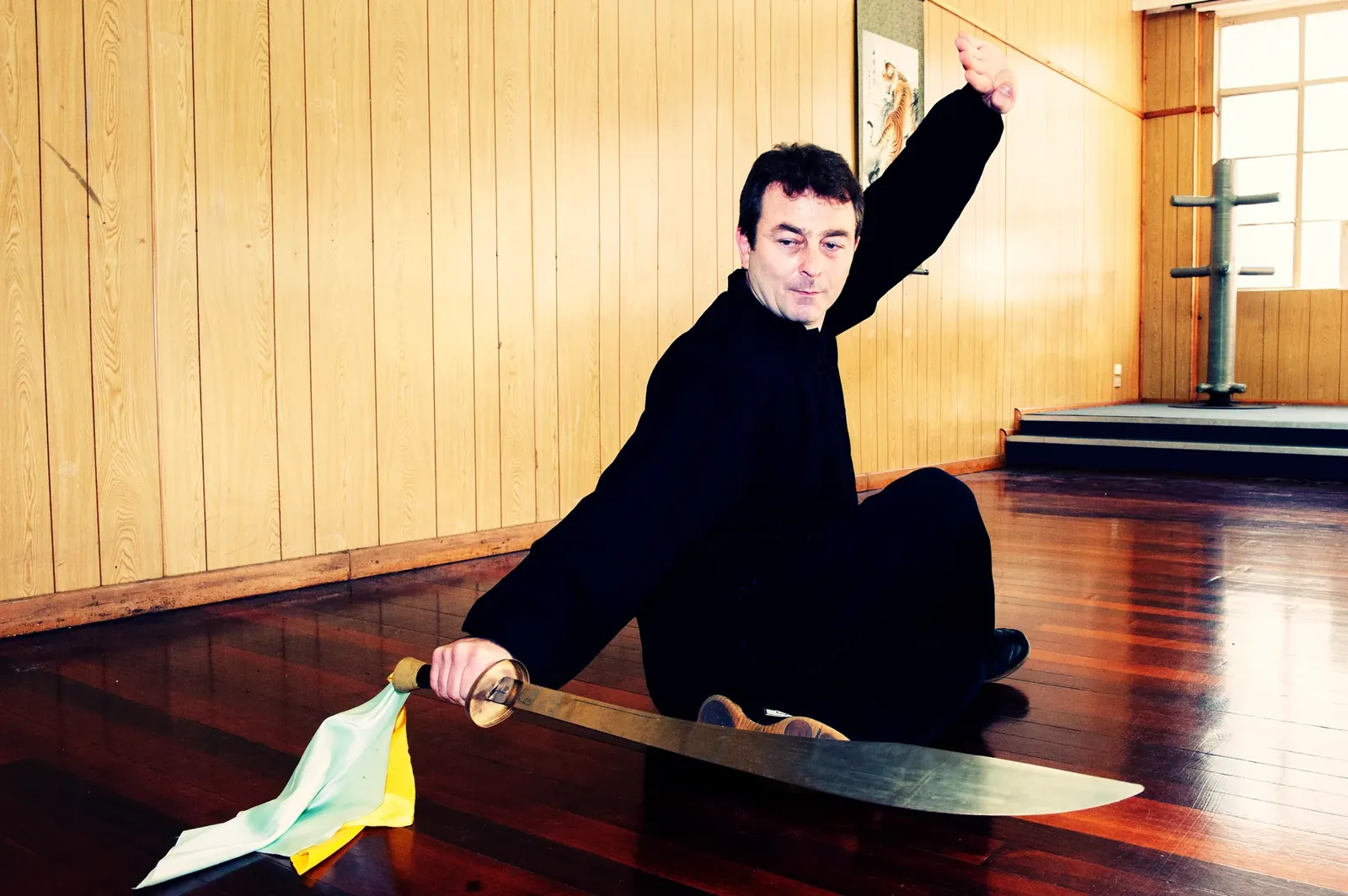 Master Marko Vesse, founder of Wu Xing Dao, seated with a Meihua dao broadsword