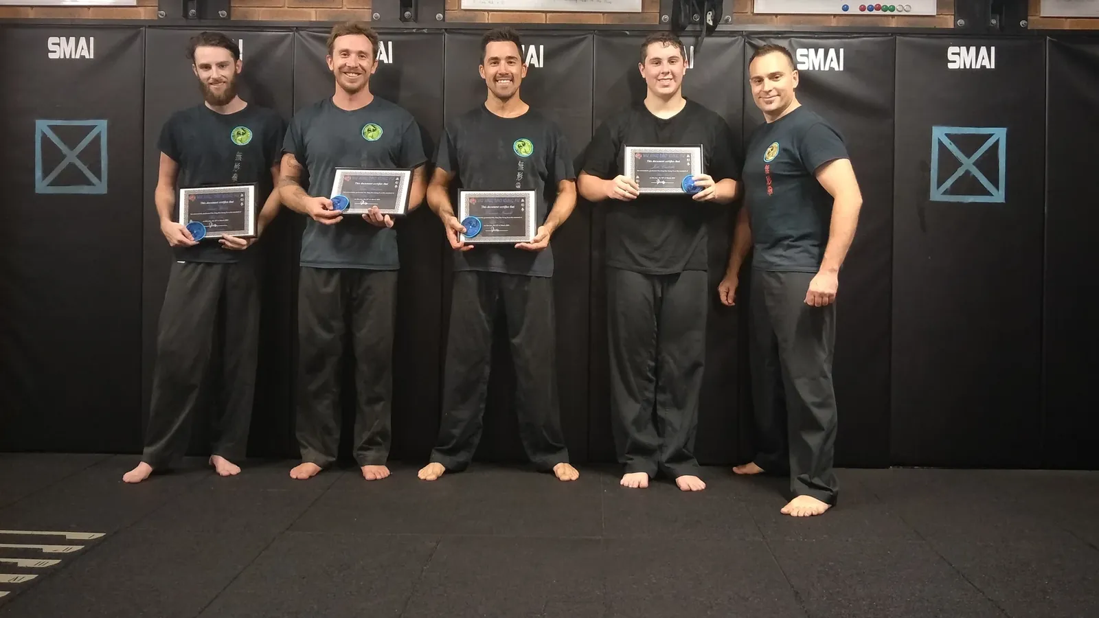 Adult students receiving their gradings with Head Instructor Grant Mundy at Wu Xing Dao