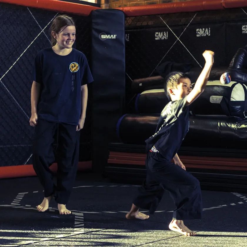 Little Dragons students practising a hammer fist strike