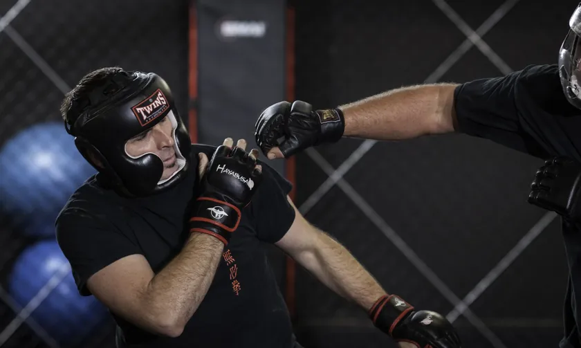 Grant and Ben sparring with head gear and gloves in a Mian Quan class