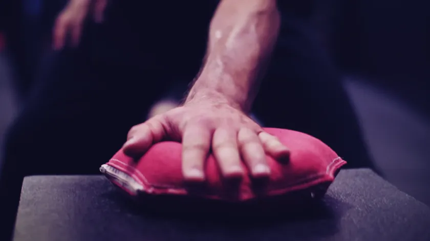 Close-up of a Steel Hand practitioner's palm on an iron palm bag