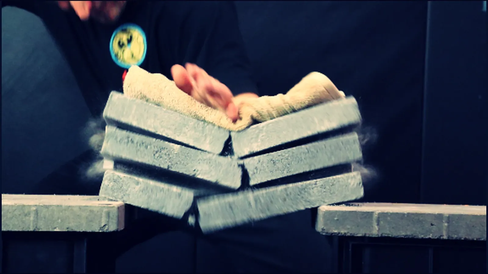Head Instructor Grant Mundy breaking a stack of three concrete caps with a Steel Hand strike