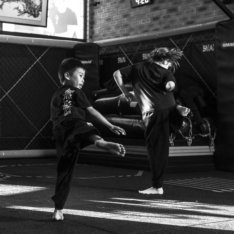 Little Dragons students training kicks together