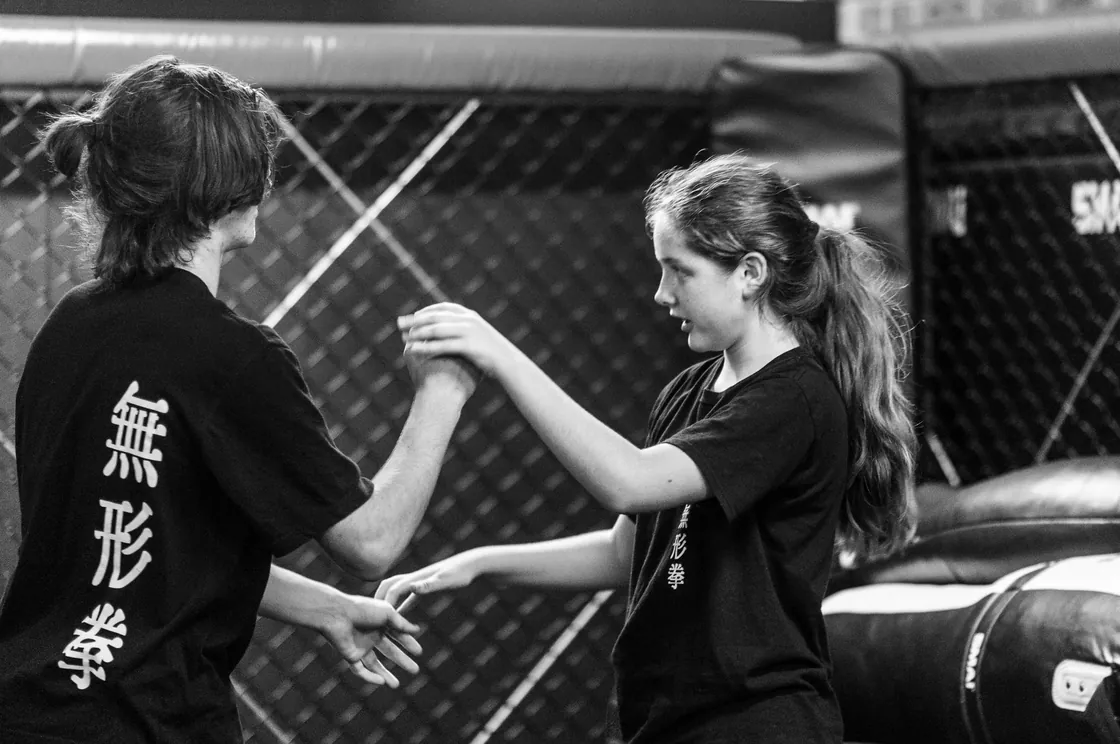 Two teen students working focus-mitt striking drills together