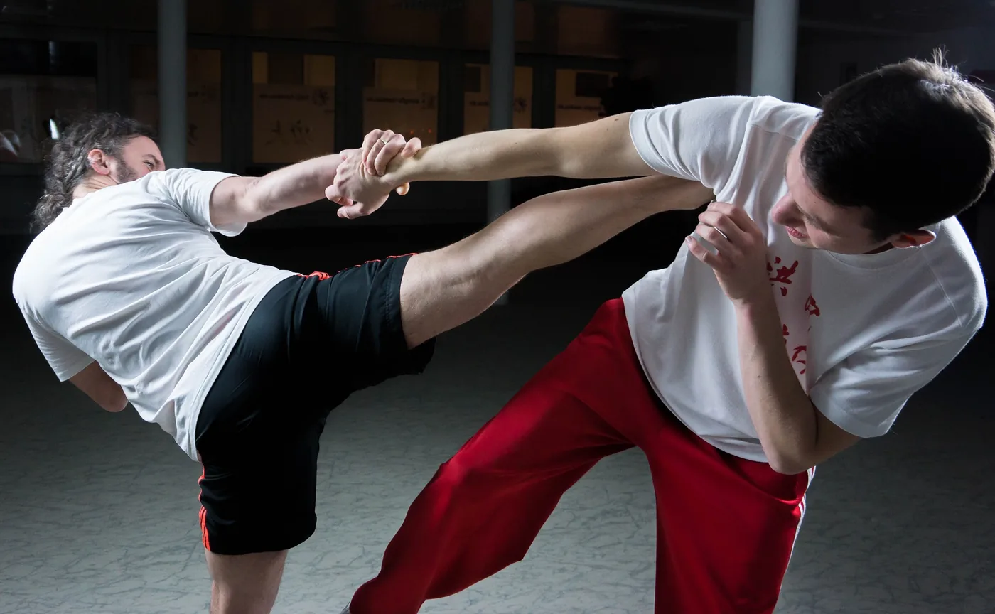 Two Kung Fu practitioners in Modern Times, sparring with their respective techniques.