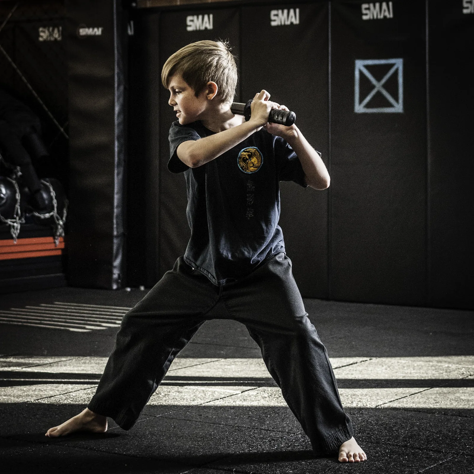 A Little Dragons student holds a focused fighting stance in the Wu Xing Dao kung fu school.