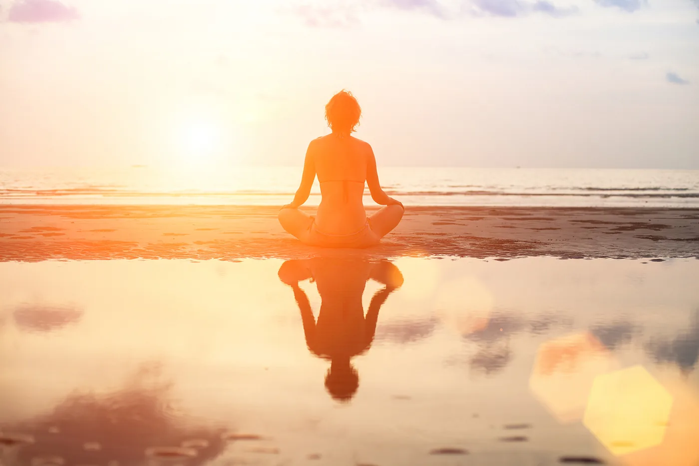 Peaceful meditation on the beach at sunrise