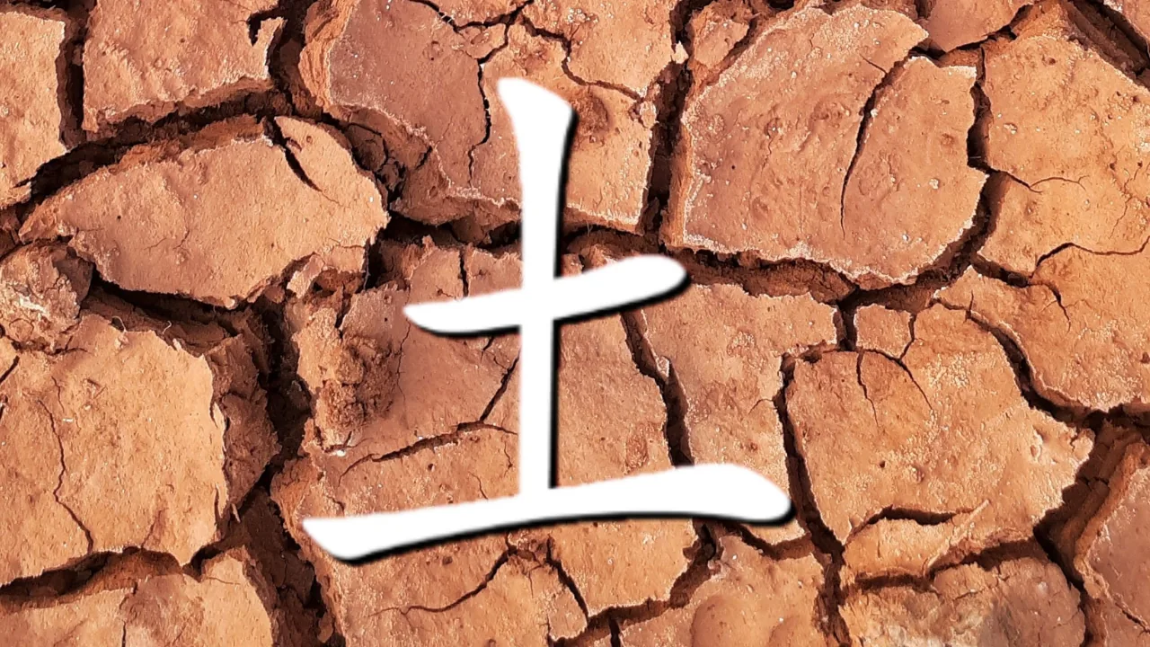 White Chinese kanji symbol for the word 'Earth' over cracked dry orange-brown earth, creating a stark, weathered look.