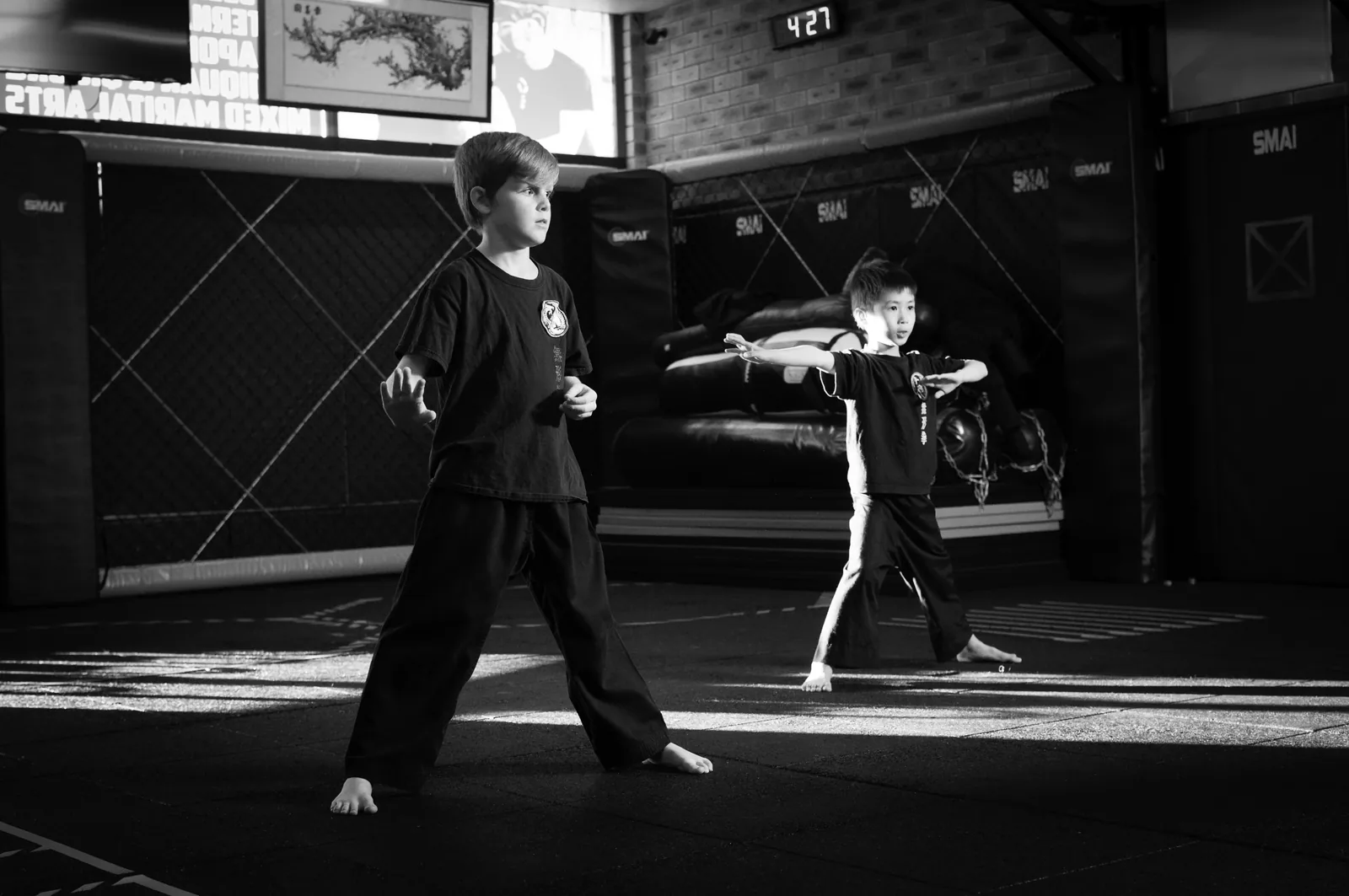 Young students hold their stances in a disciplined line.