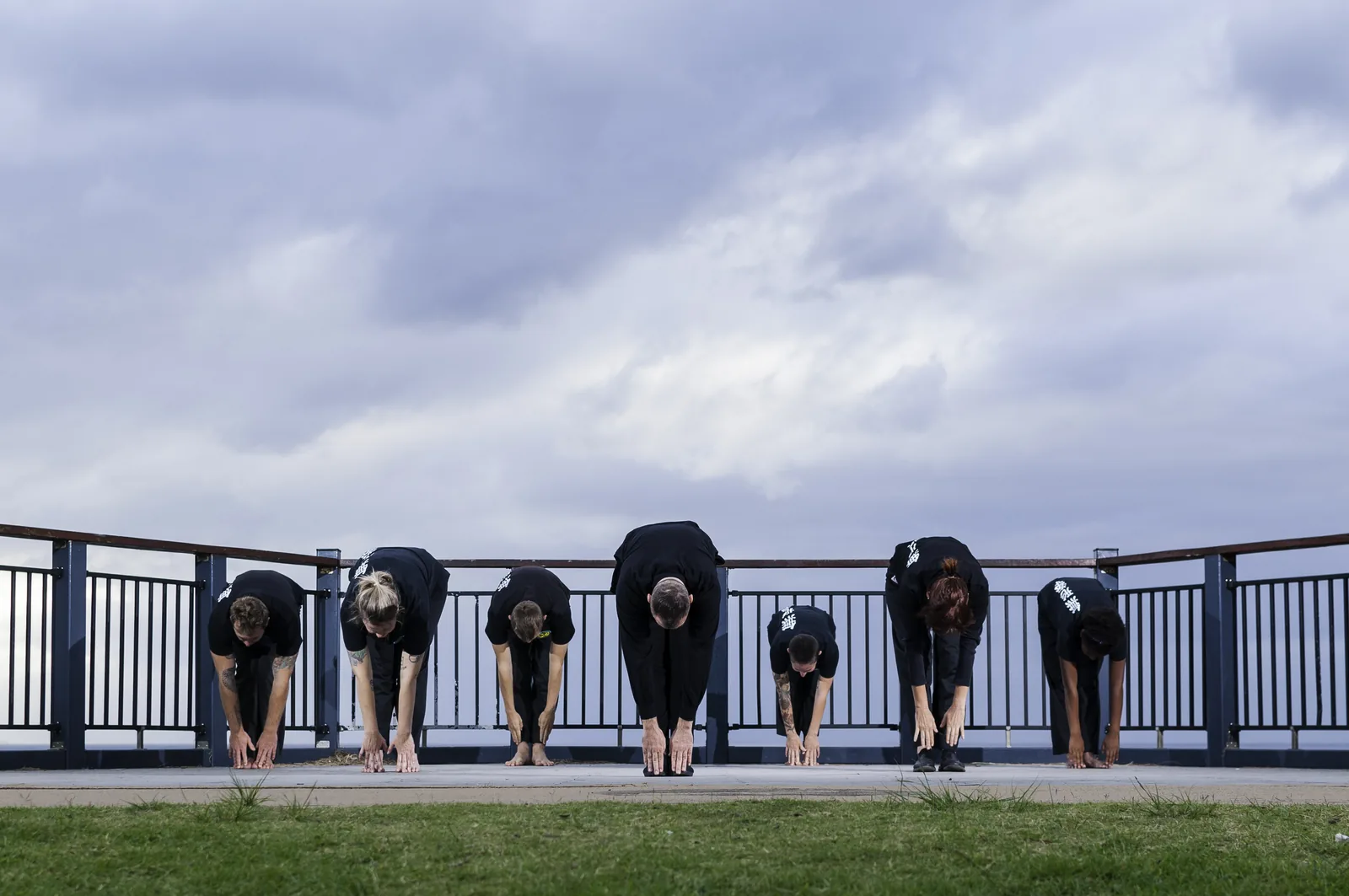 Students bow together at the end of practice on the Terrigal lookout.