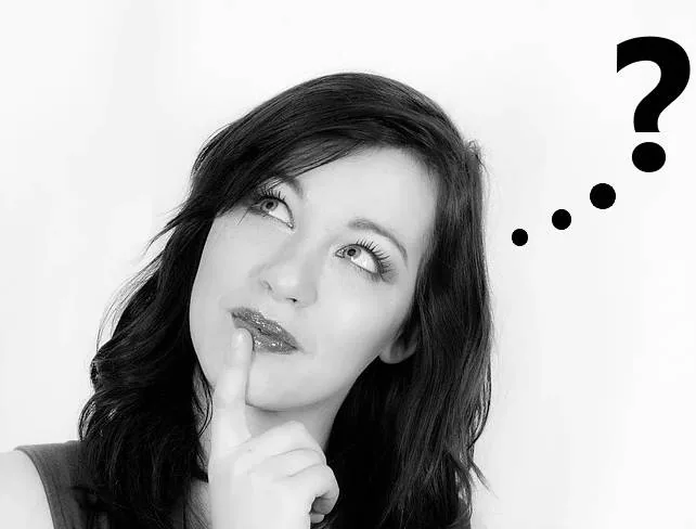 Black-and-white portrait of a woman thinking, finger on chin, looking up at a large question mark and dots on a white background