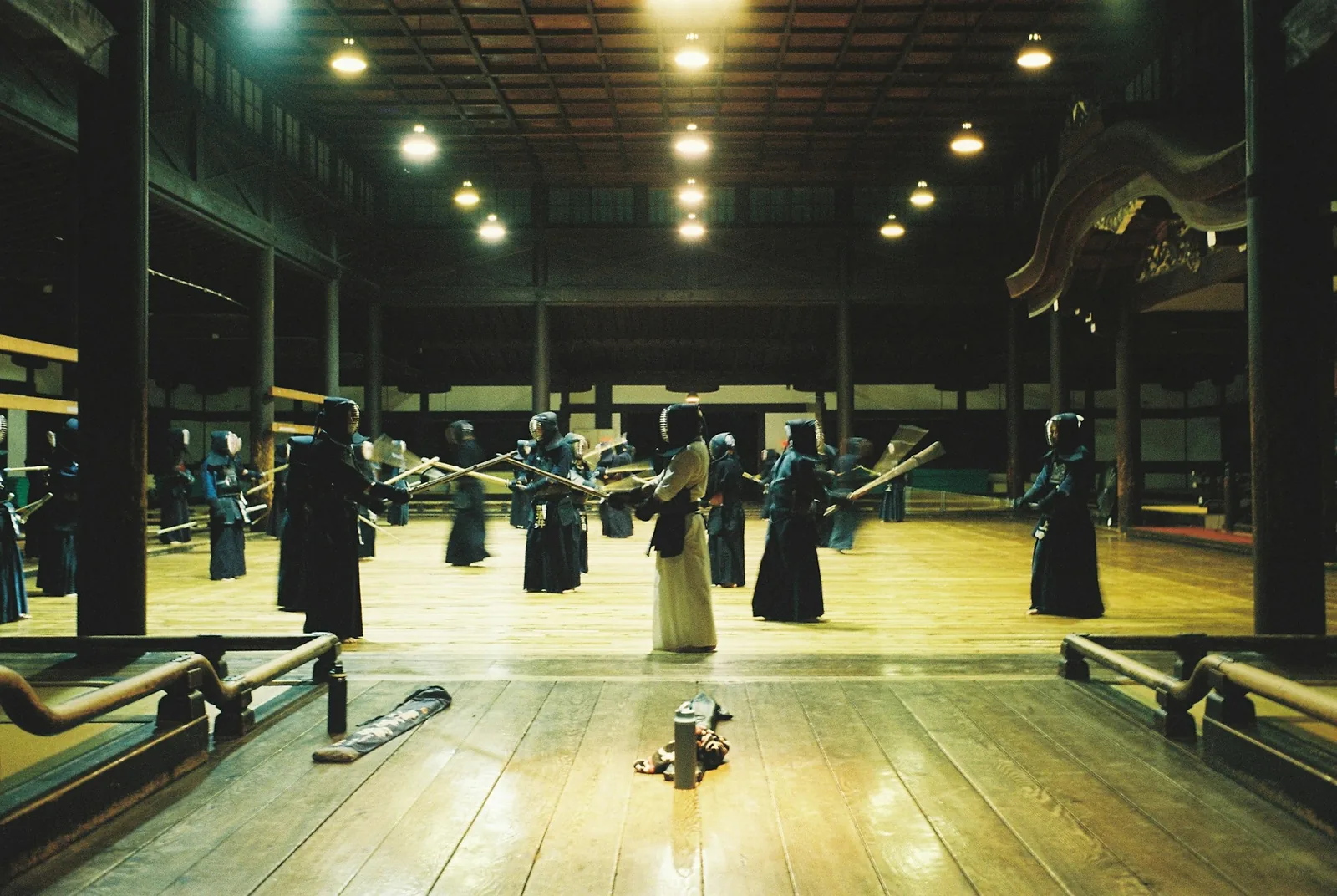 Kendo practitioners in armour training in a traditional Japanese dojo.