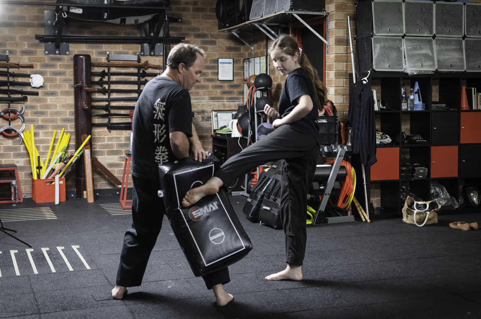 A powerful roundhouse kick into a kick shield held by a training partner.