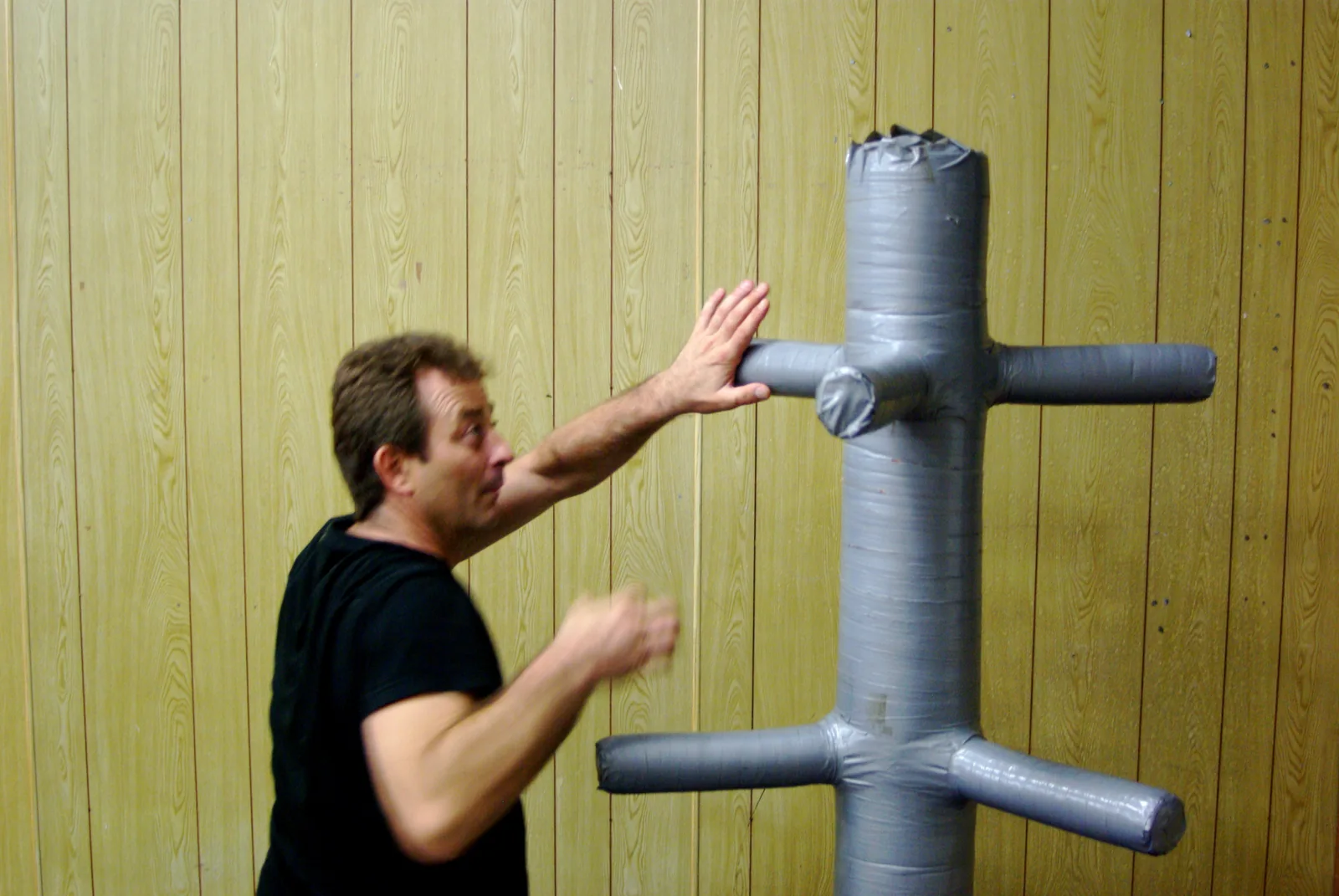 Training trapping hands on a wooden dummy.