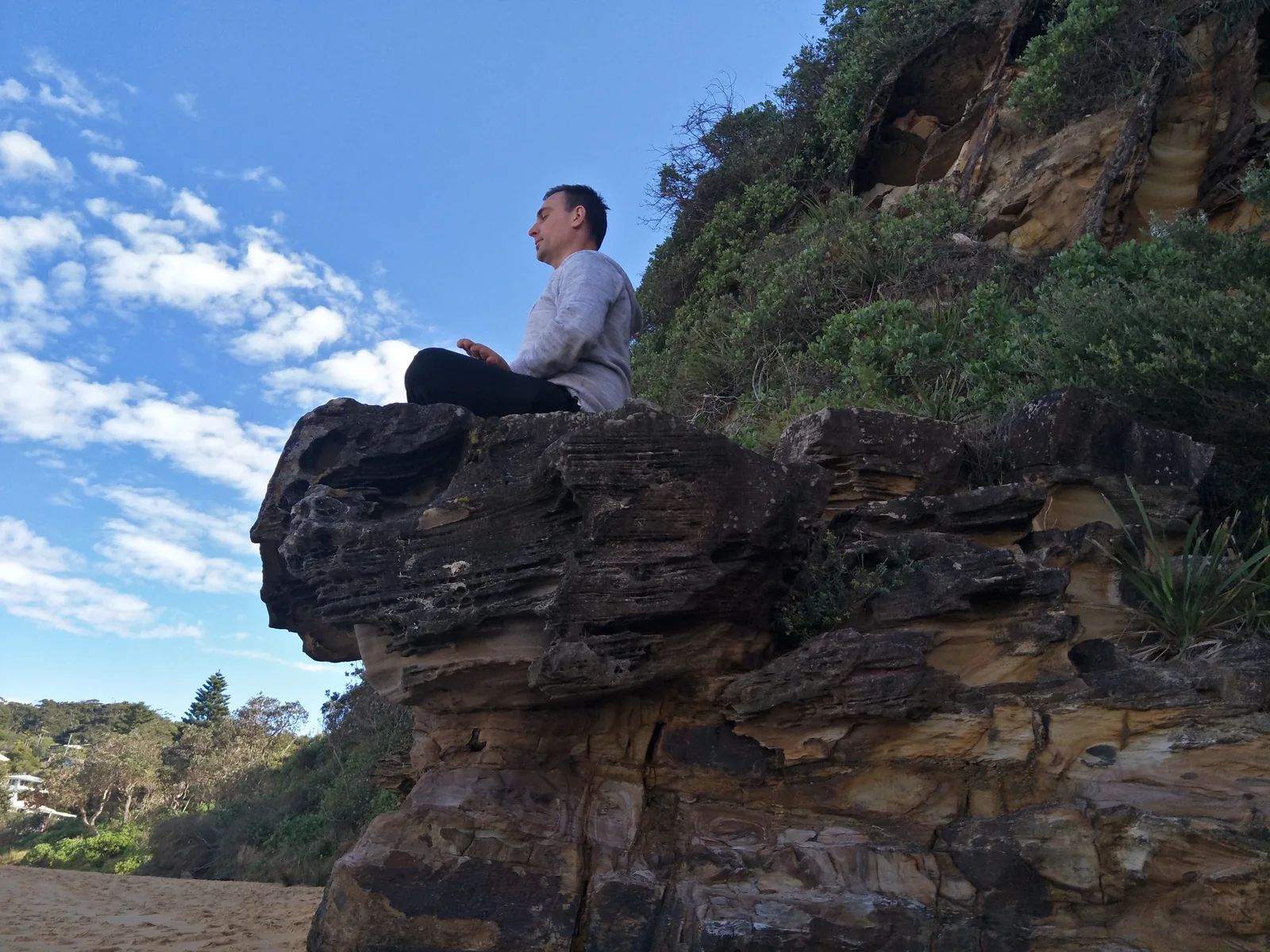 Seated meditation on a sandstone ledge above Macmasters Beach.