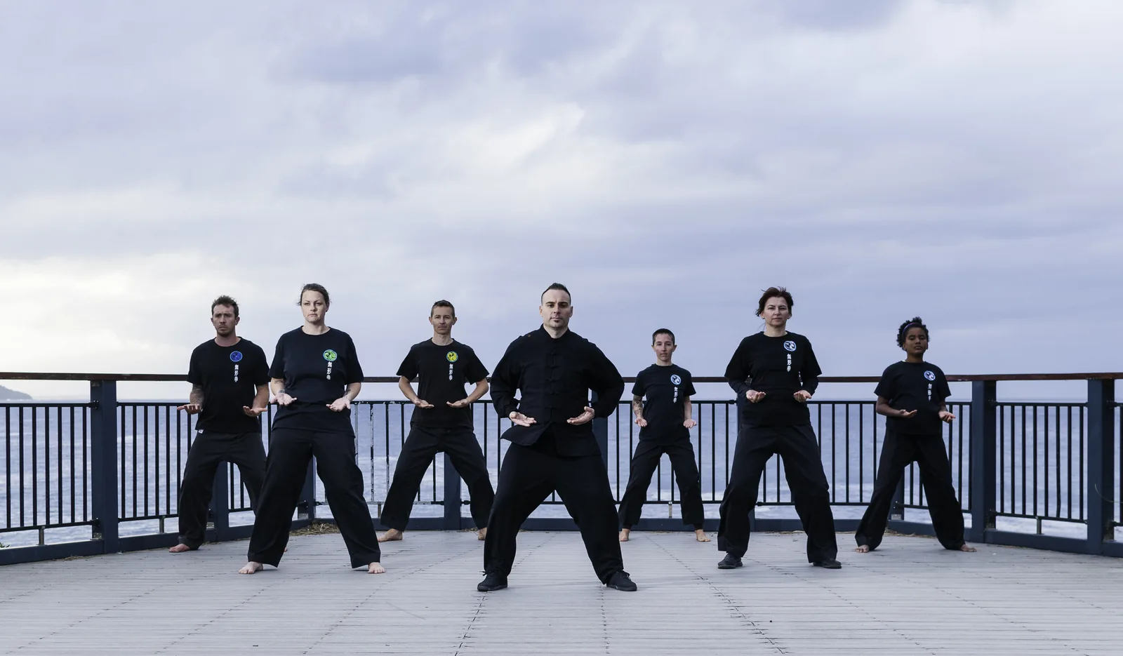 A Qigong class practises together on the Terrigal lookout.