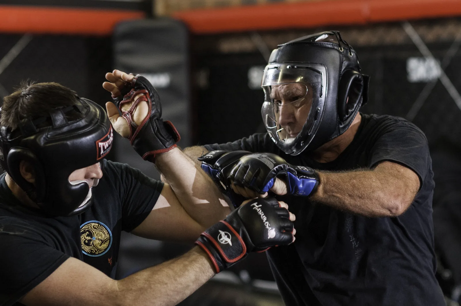 Students in headgear trade punches during sparring.