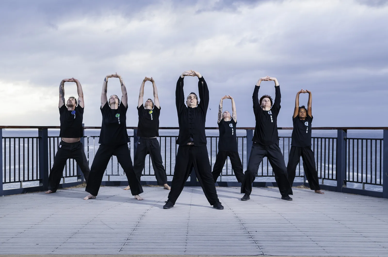 A group practises Qigong together on the Terrigal lookout.