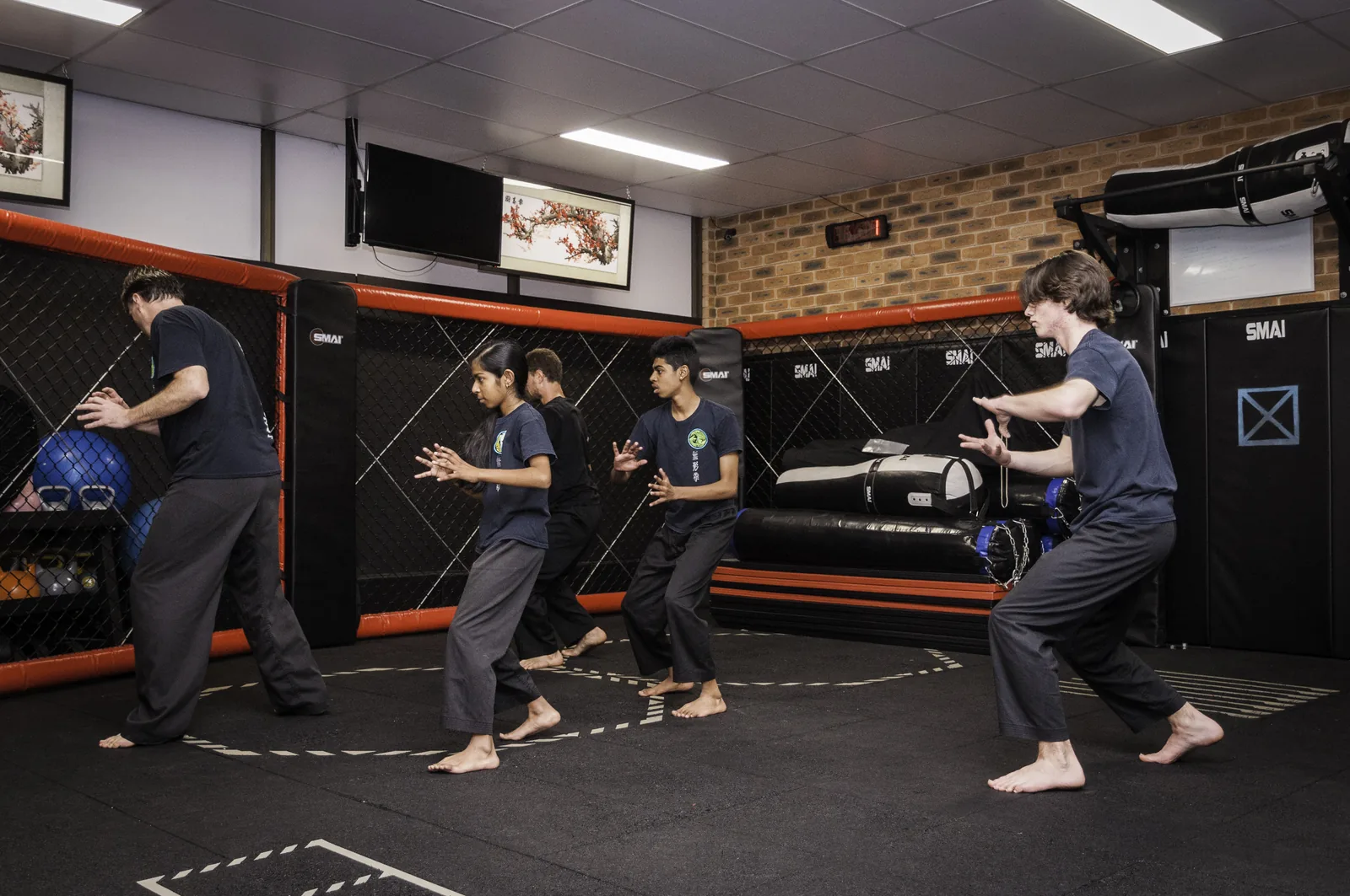 An evening class trains together in the Wu Xing Dao school in Wyoming NSW.