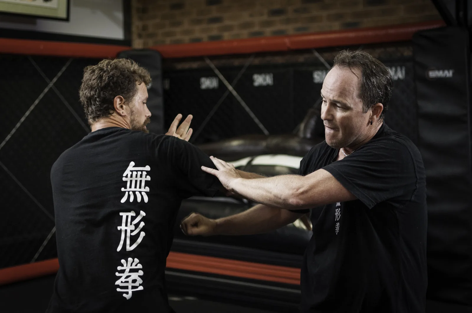 Two students practise close-range trapping hands.